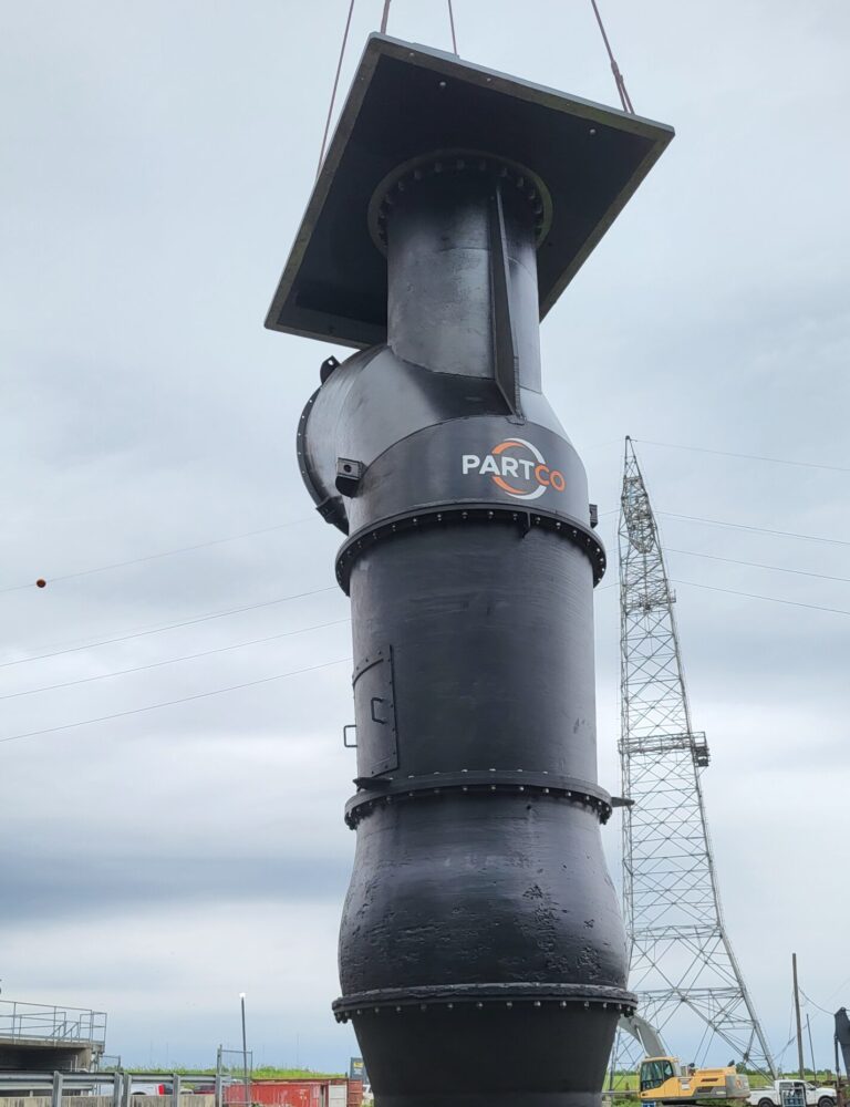 A large black industrial pipe section labeled 